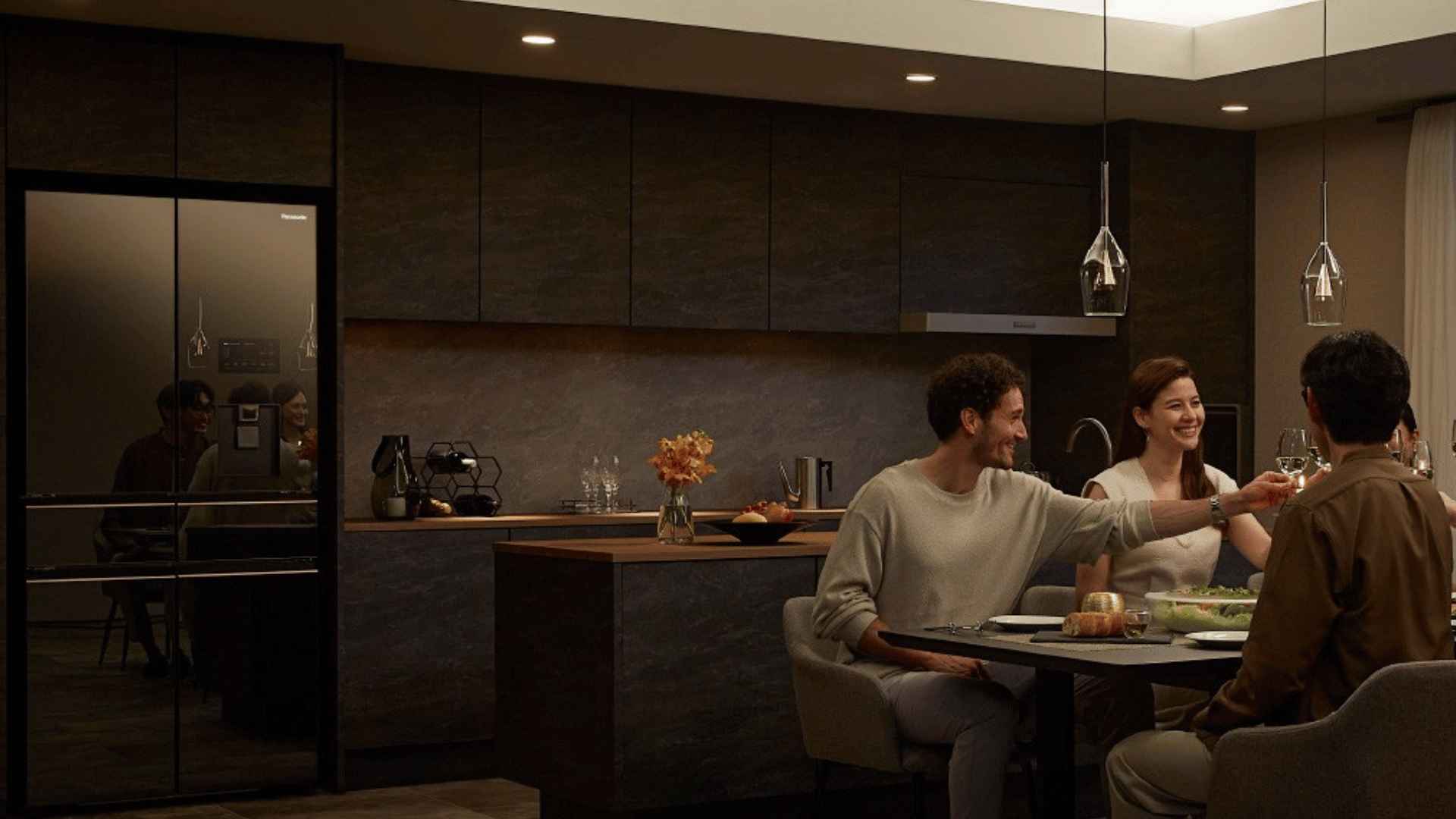 Family dining together in a modern kitchen with warm lighting.