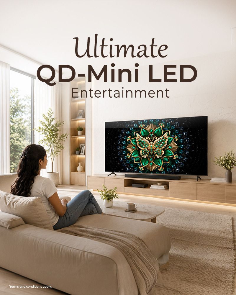 A women watching TCL C6K Series TV in a modern living room
