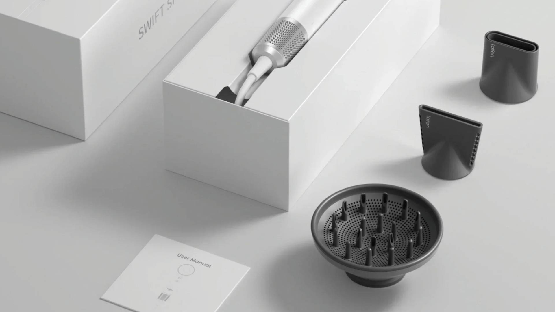 Laifen hair dryer placed beside various nozzle and diffuser attachments.