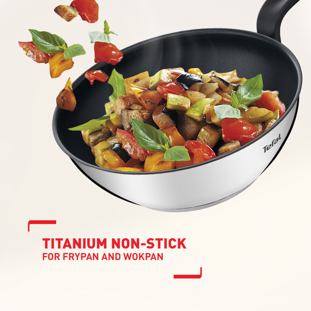 Titanium non-stick Tefal wok with vegetables tossing inside
