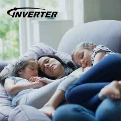 Mother and two children sleeping comfortably on a sofa under inverter air conditioning.
