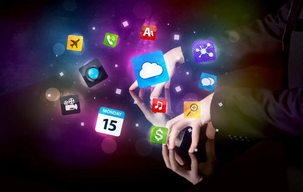 Hands interacting with a vibrant digital interface of colorful app icons, representing the diverse ecosystem of productivity apps like Notion and Trello available for the iPhone 15 Pro.