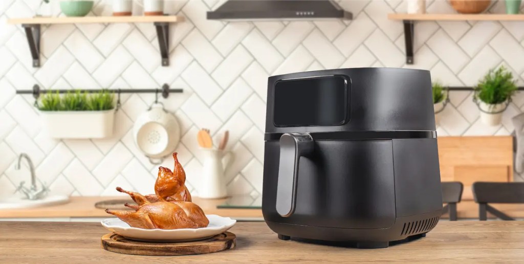 Airfryer Malaysia online guide from senQ Malaysia. Baked quail cooking inside a modern air fryer oven in a kitchen.